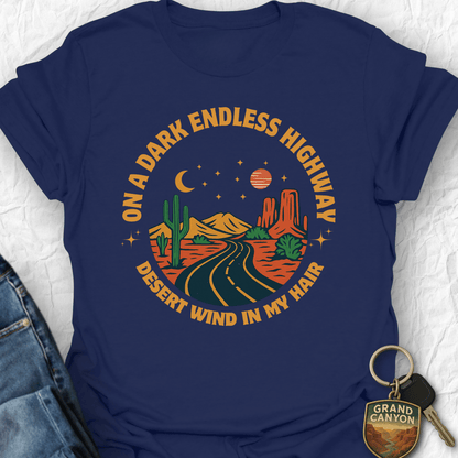 Navy blue t-shirt with desert-themed graphic and text on a textured white background