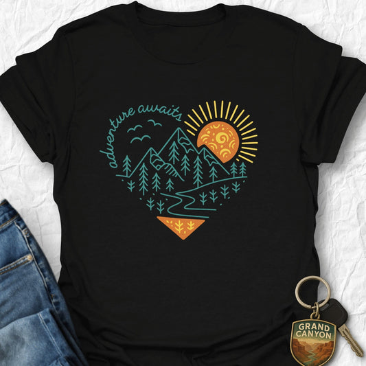 Black t-shirt with nature-themed design and keychain on a textured surface