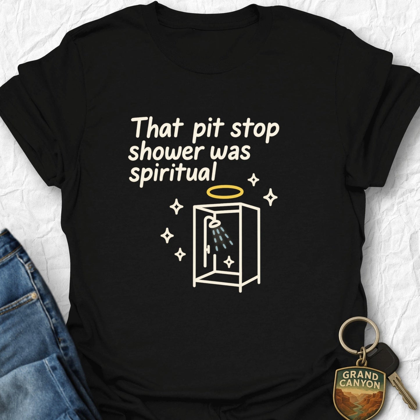 Black t-shirt with humorous graphic and text on a white background