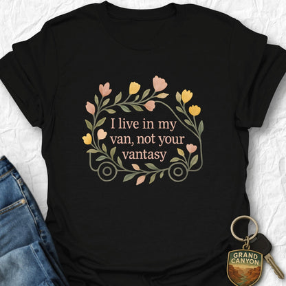 Black t-shirt with floral design and text, paired with jeans and a keychain on a white background