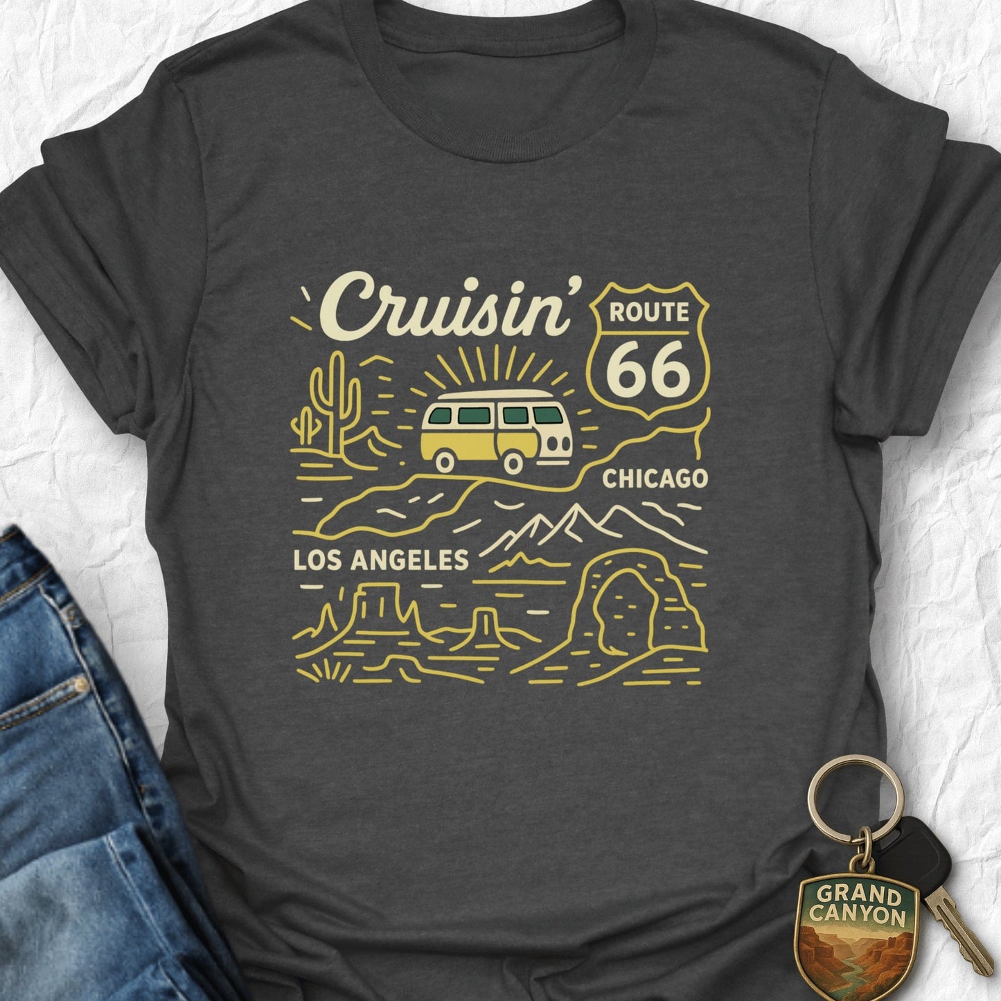 Dark gray t-shirt with 'Cruisin' Route 66' graphic design on a textured white background.