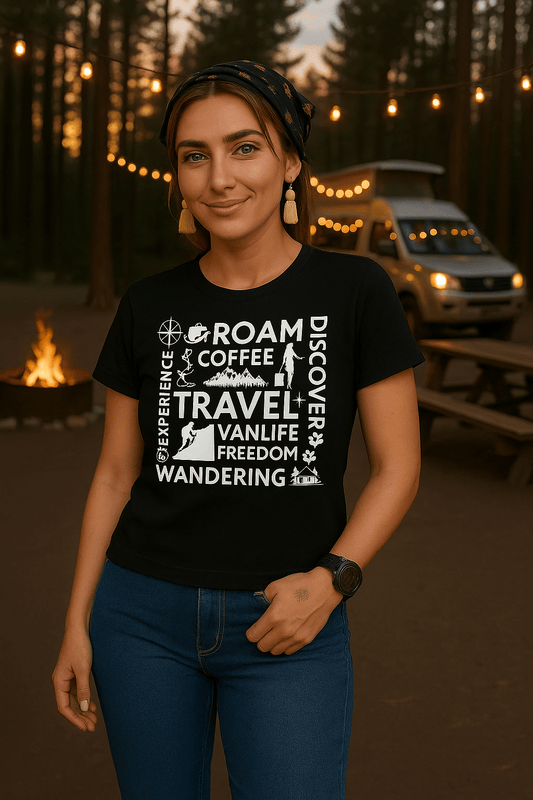 Woman wearing a black t-shirt with white text and graphics in a forest setting with lights and a van.