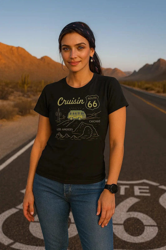 Woman wearing a black t-shirt with Route 66 graphic on a desert road with mountains in the background.